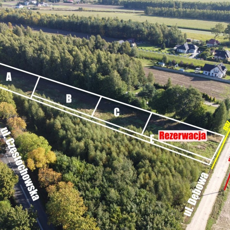 Aerial view of a wooded lot with three rectangular plots A, B, C and a reserved area labeled 'Rezerwacja' along a roadside.
