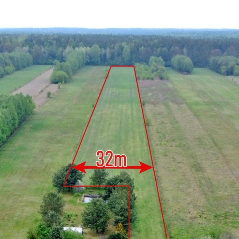 Aerial view of a long, narrow grassy plot outlined in red with a 32 m width label and surrounding trees.