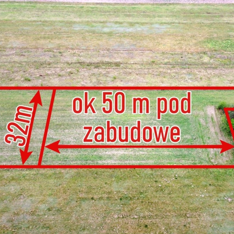 Aerial view of a vacant plot with red boundary lines, labeled 'ok 50 m pod zabudowe' and '32m'.