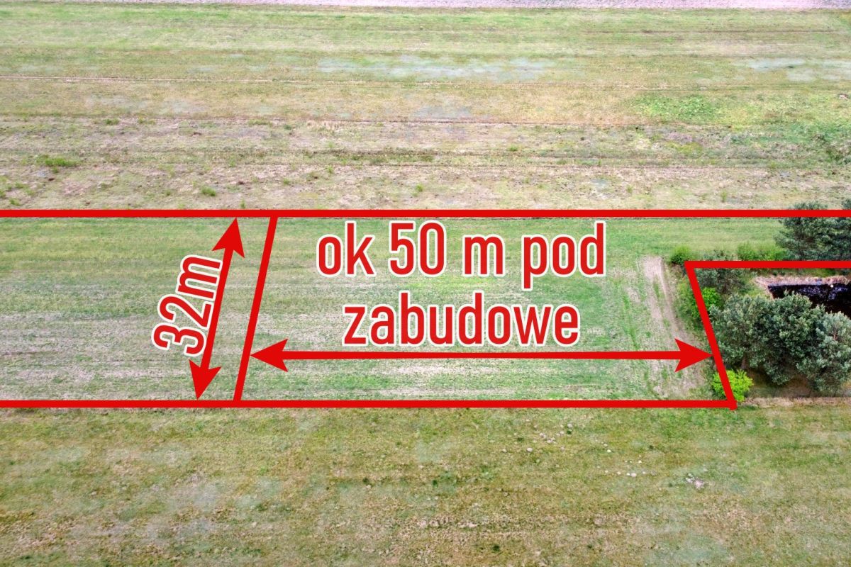 Aerial view of a vacant plot with red boundary lines, labeled 'ok 50 m pod zabudowe' and '32m'.