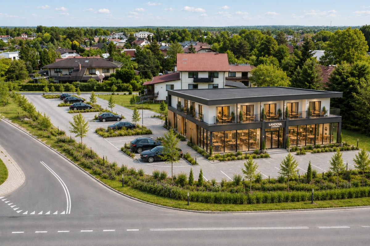 107883542.jpg Modern two-story glass-front office building with a sign reading 'LANDOVA', surrounded by a parking lot and landscaped greenery in a suburban area.