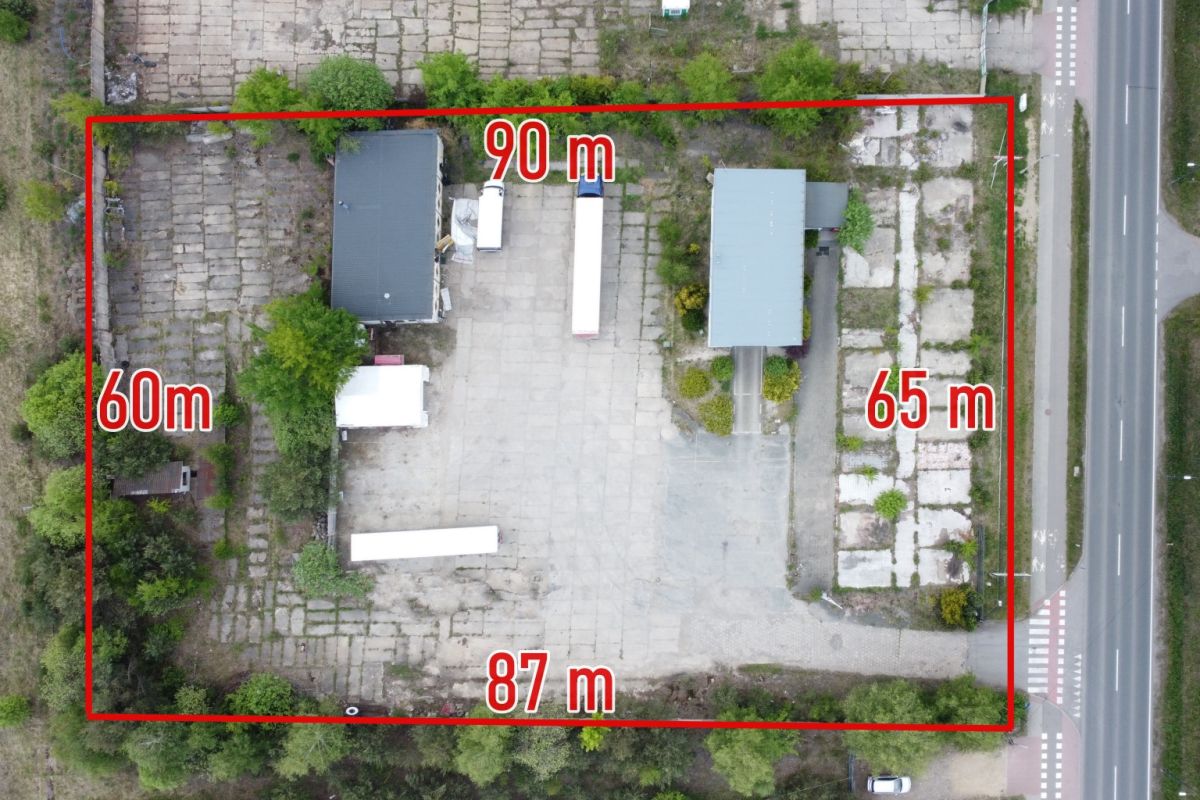 Aerial view of a rectangular lot outlined in red with labeled side lengths (top 90 m, left 60 m, right 65 m, bottom 87 m) showing several buildings and trees inside.
