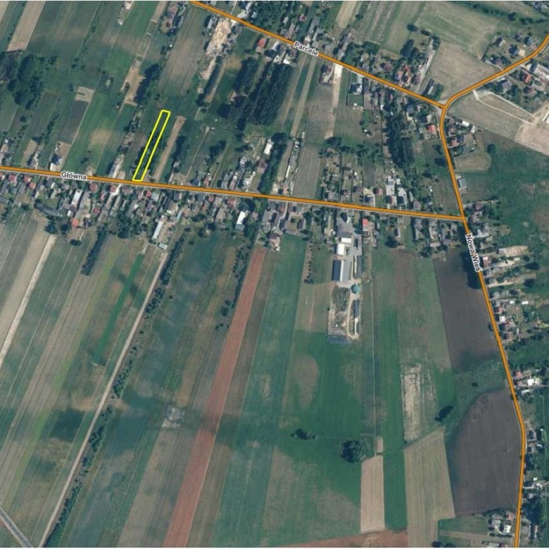 Aerial map showing a small yellow-outlined rectangular plot along Glowna Street near a village crossroads.