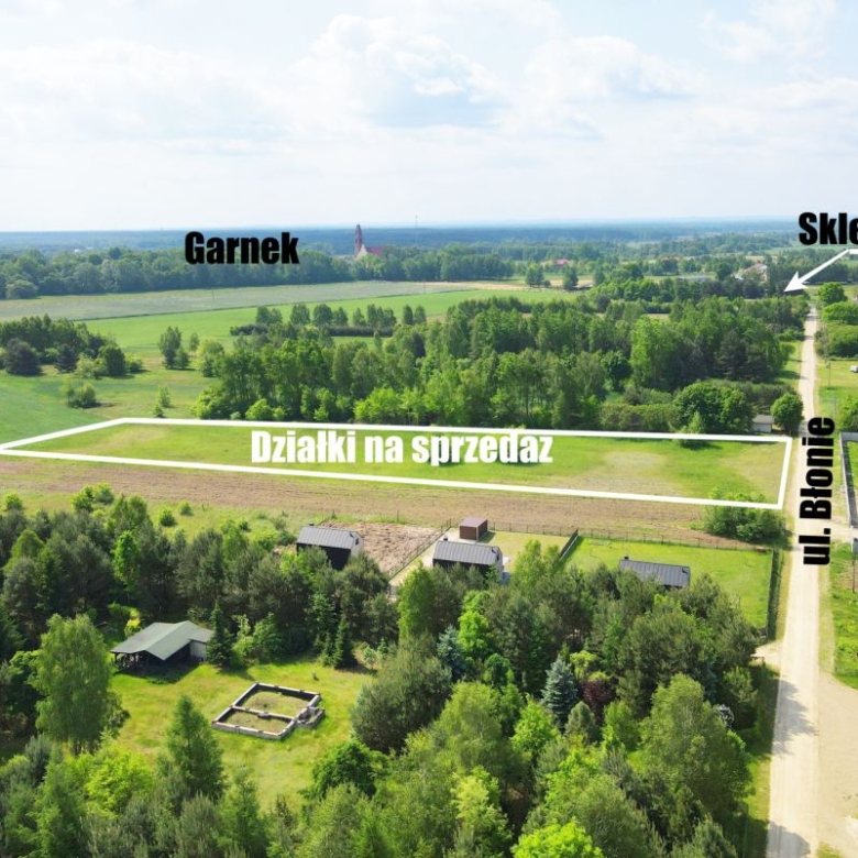 Aerial view of a rural area showing a rectangular plot labeled 'Działki na sprzedaż' along Ul. Błonie, near Garnek with a road and small buildings nearby (Polish real estate map).