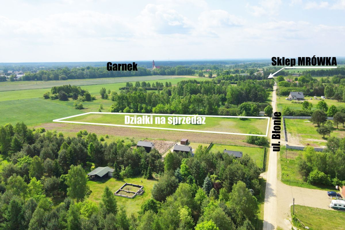 Aerial view of a rural area showing a rectangular plot labeled 'Działki na sprzedaż' along Ul. Błonie, near Garnek with a road and small buildings nearby (Polish real estate map).