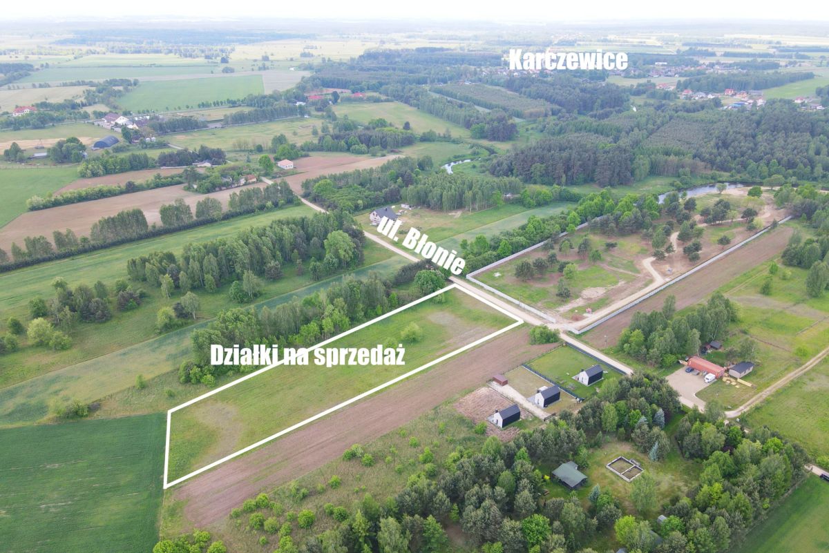 Aerial view of rural plots outlined in white for sale, labeled 'Działki na sprzedaż' near Ul. Błonie, Kartzewice