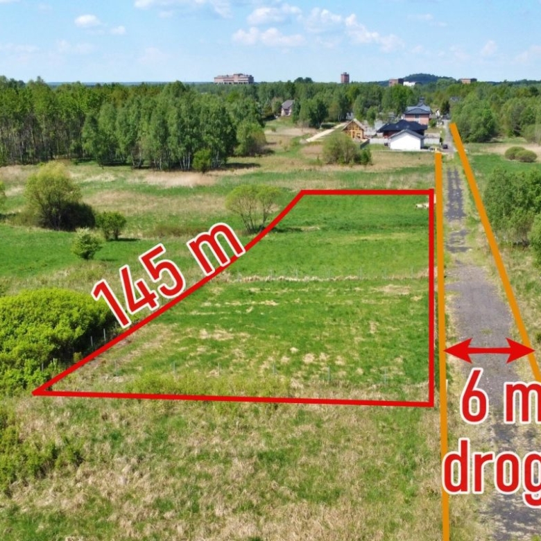 Aerial view of a vacant triangular plot outlined in red with a 145 m edge, beside an orange road marked 6 m wide.