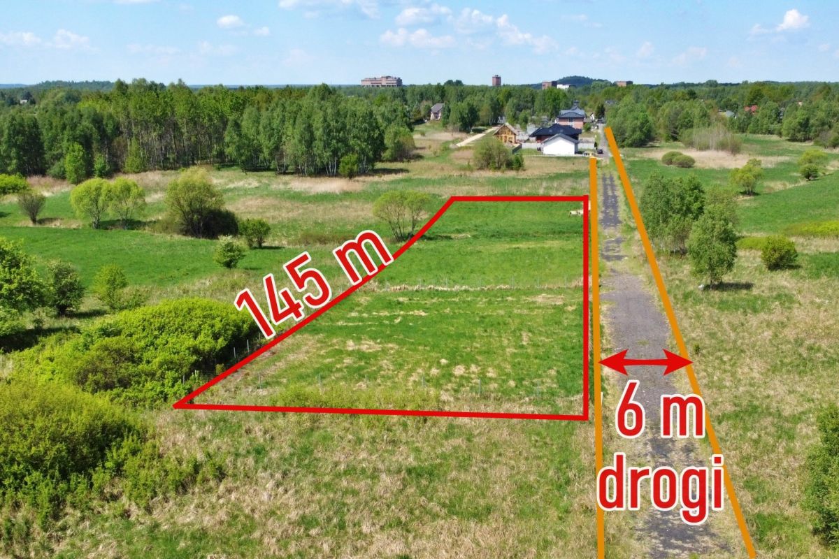 Aerial view of a vacant triangular plot outlined in red with a 145 m edge, beside an orange road marked 6 m wide.