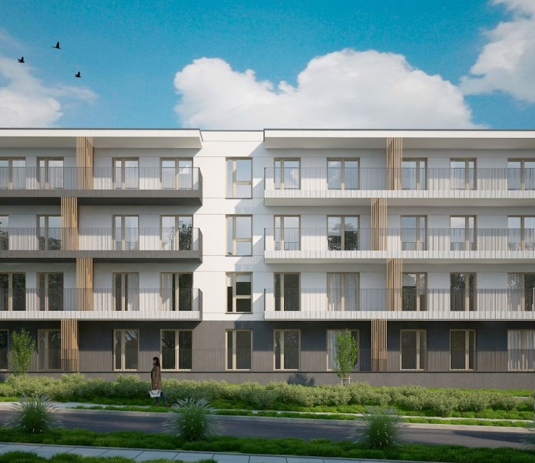 Modern 4-story apartment building with white and gray facade, spacious balconies, and landscaped ground level.