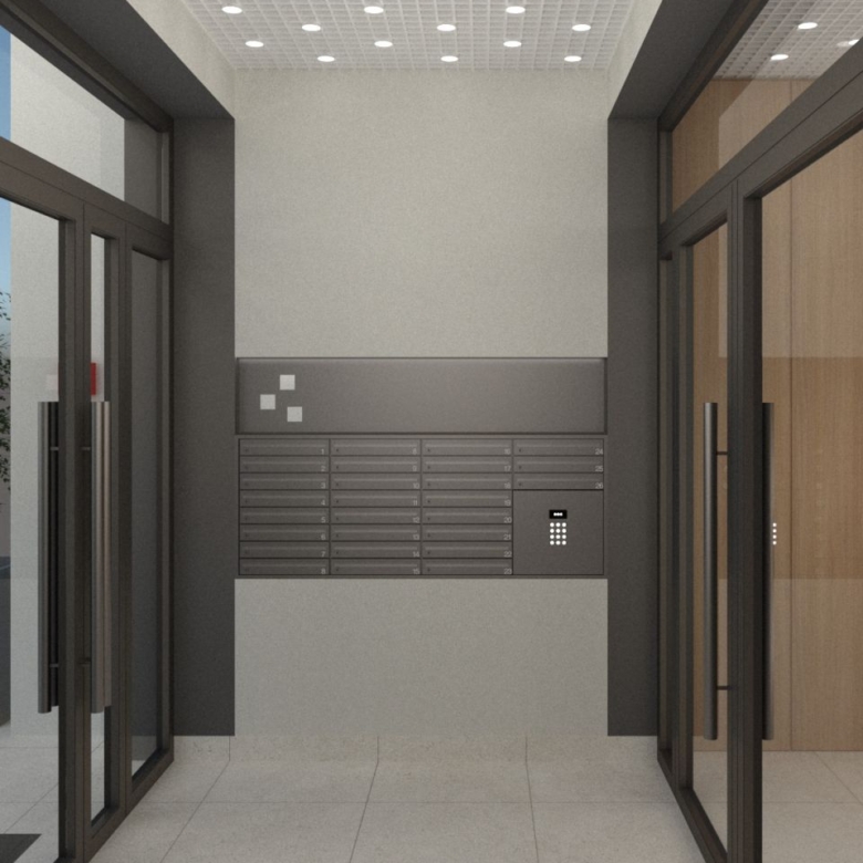 Modern building lobby with wall-mounted mailboxes and a small keypad at the right, near glass entrance doors.