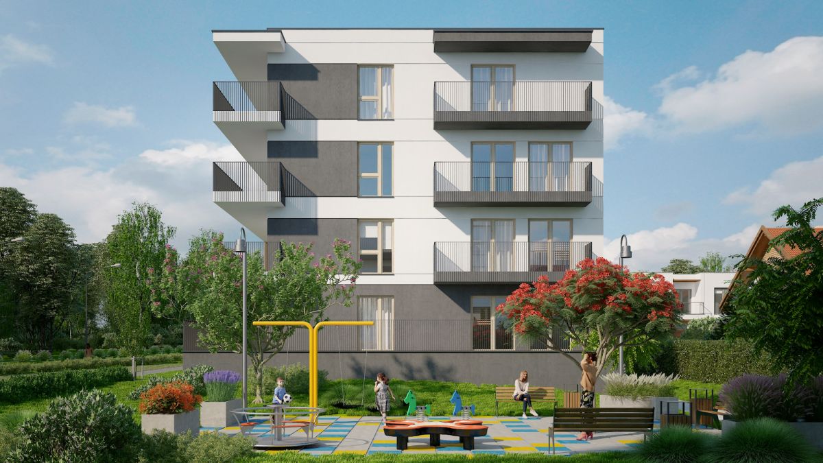 Modern four-story apartment building with balconies overlooking a green park and a children's playground in front.