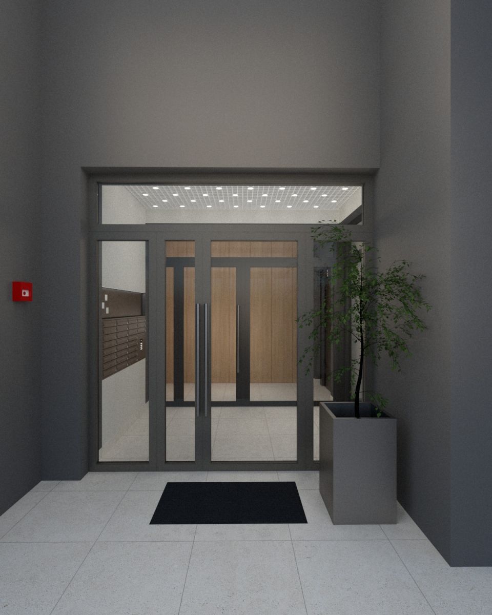 Glass double doors to a modern lobby with a black mat, gray frame, a row of mailboxes to the left, and a tall plant in a gray planter on the right.
