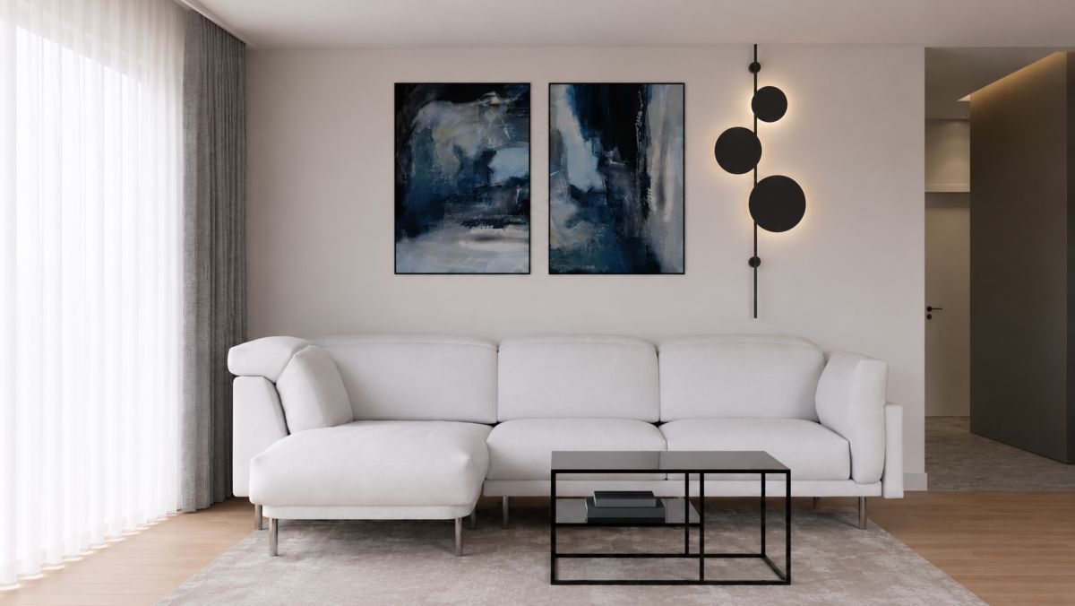 Modern living room with a white sectional sofa, two abstract blue paintings, and a black metal coffee table