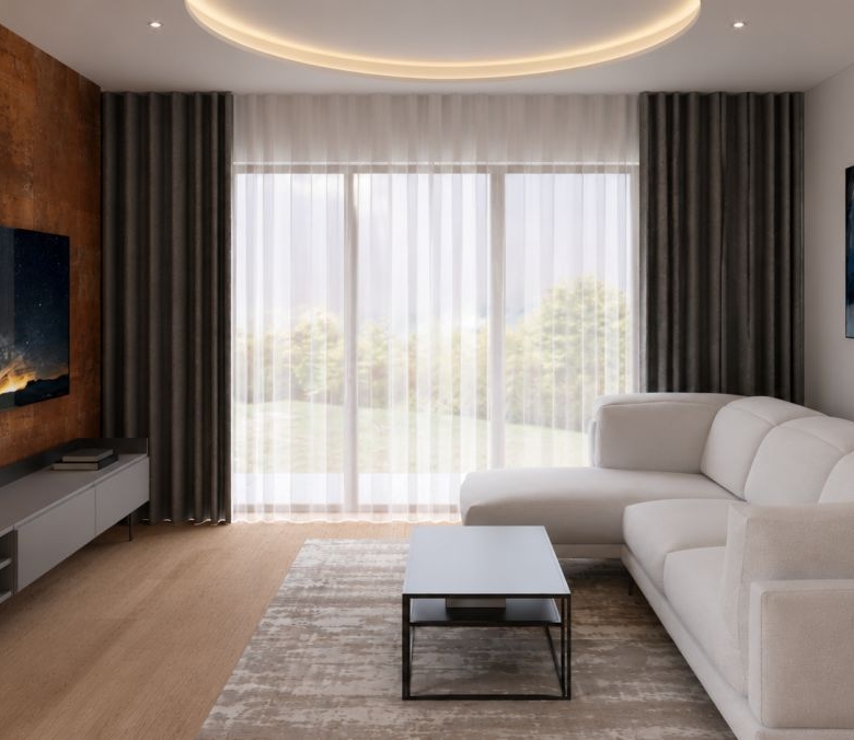 Living room with rust accent wall, wall-mounted TV, gray media console, and a white sectional sofa.