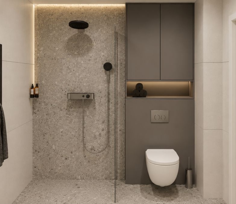 Modern bathroom with a wall-mounted toilet, open shower area, and built-in gray storage cabinets in a minimalist design.