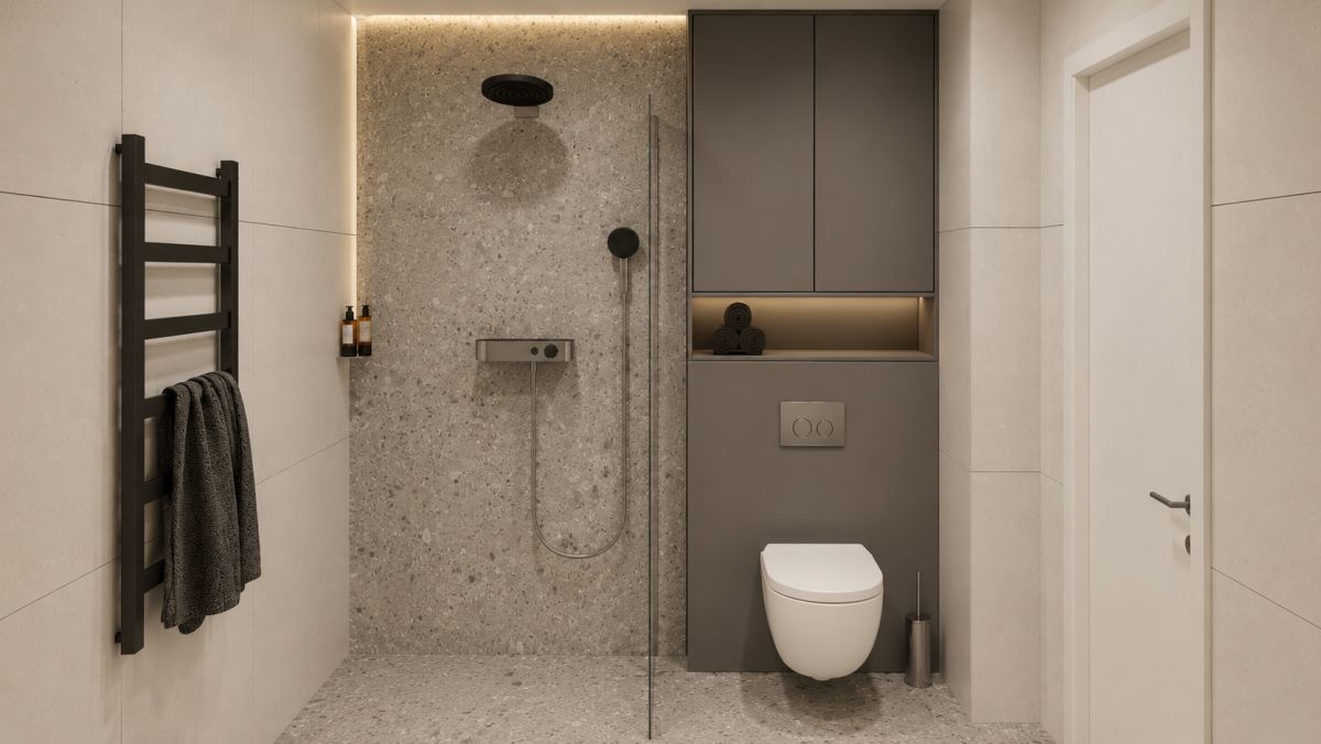 Modern bathroom with a wall-mounted toilet, open shower area, and built-in gray storage cabinets in a minimalist design.