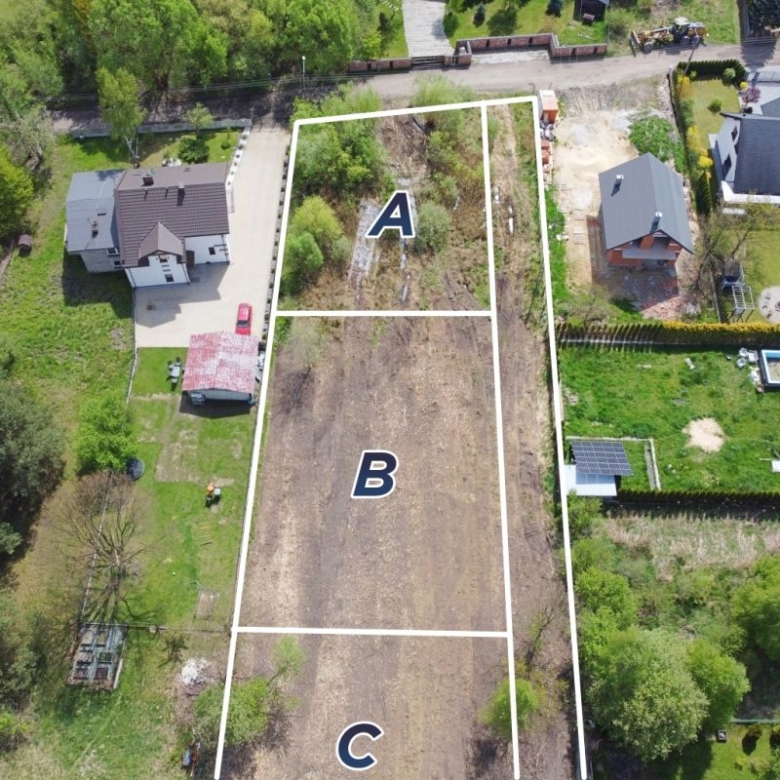 Aerial view of three adjacent plots labeled A, B and C with white boundary lines in a residential area.