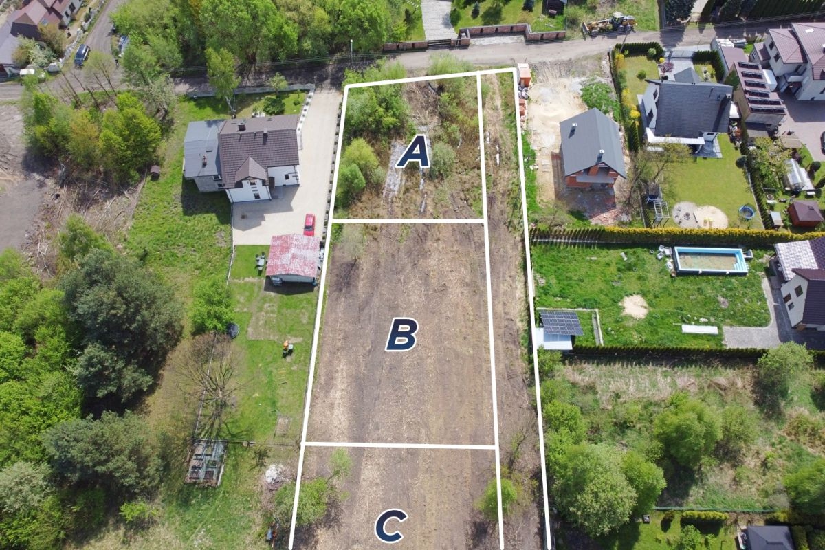 Aerial view of three adjacent plots labeled A, B and C with white boundary lines in a residential area.