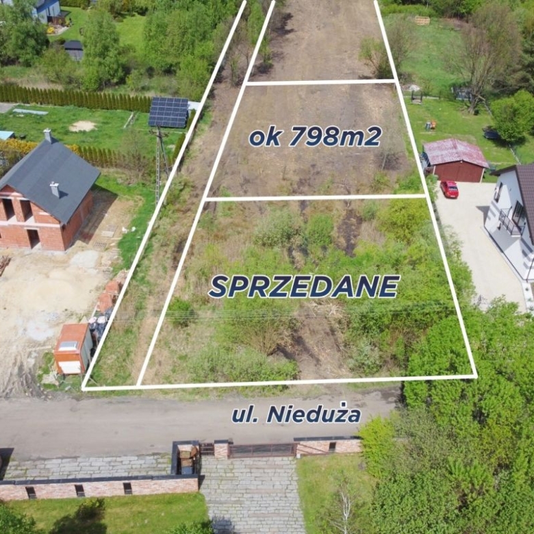 Aerial view of a vacant plot outlined in white, labeled ok 798m2 and SPRZEDANE, on ul. Nieduża between houses.